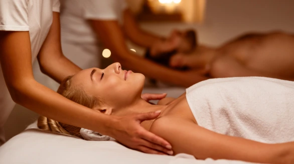 a couple is laying on massage table getting Swedish massage at their home